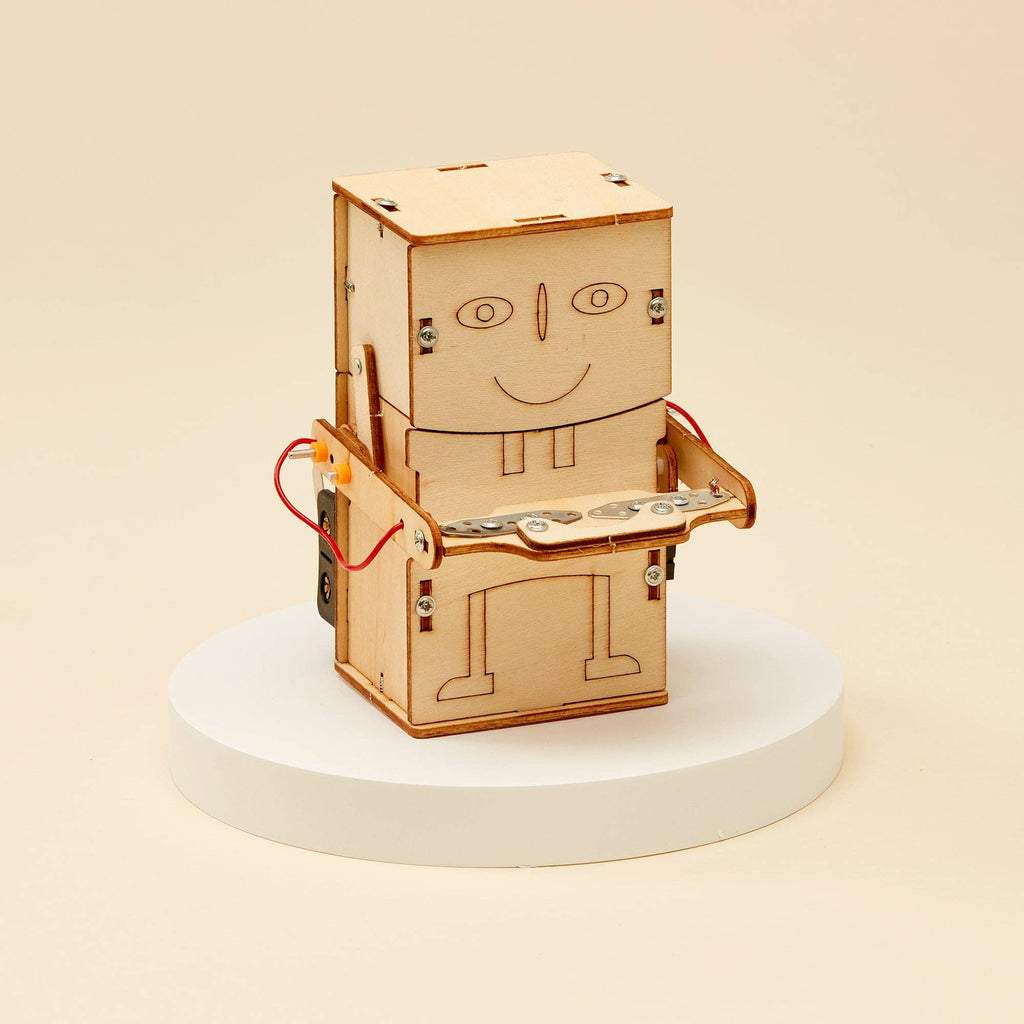 Money Bank Robot DIY Kit, STEM Toy for Kids showing fully assembled robot, place money in it's stand and watch him eat it